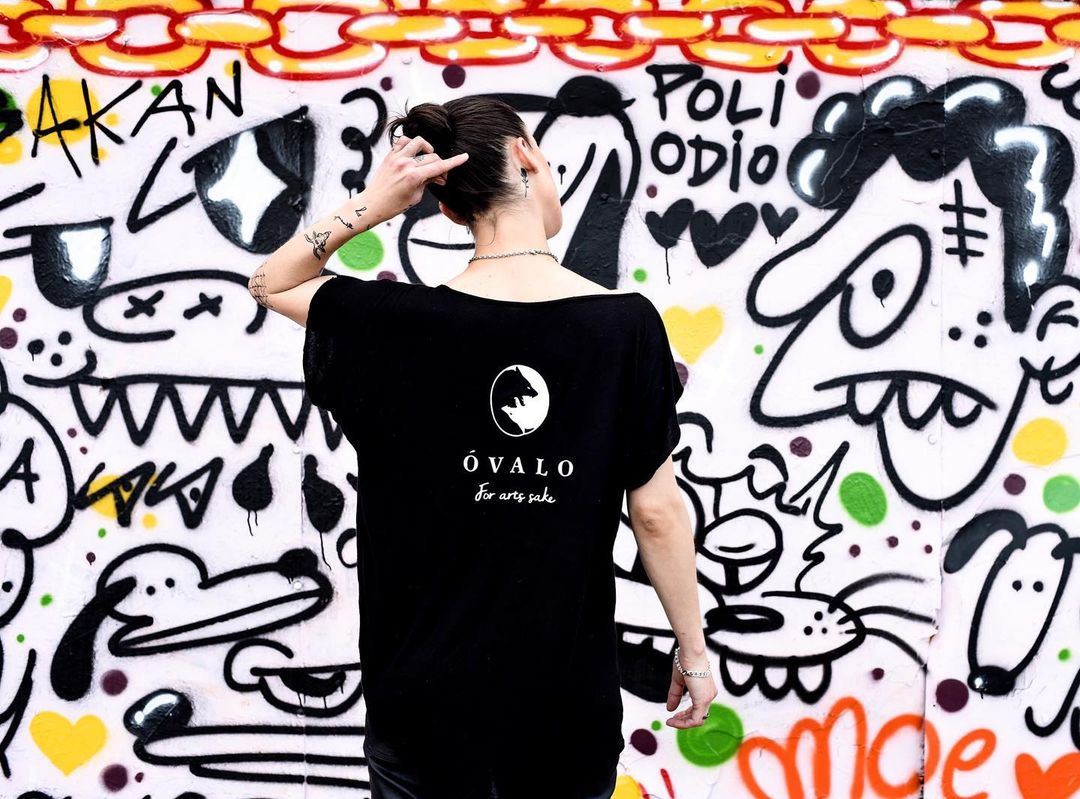 For Art's Sake tee with signature print against a graffiti wall